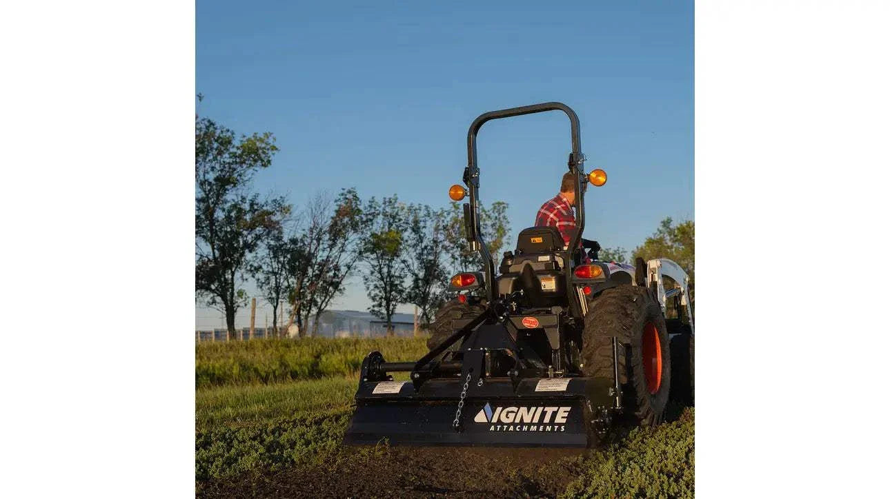 72 Inch 3-Point Tiller attached to tractor cultivating soil in a field.